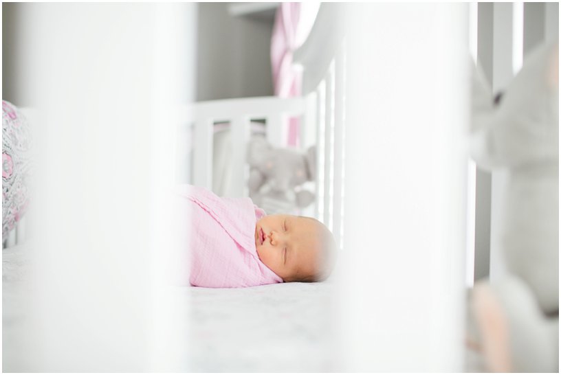 newborn baby in white crib 