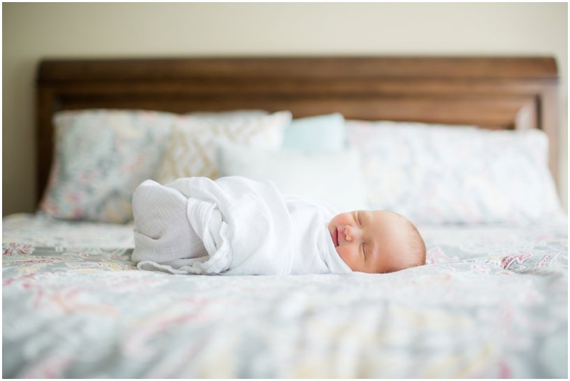 newborn photos done on a bed 